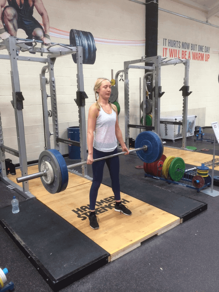 A person performing an exercise with a barbell