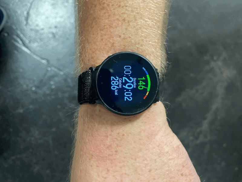 A sports watch displaying heart rate, time elapsed, and calories burnt