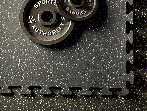 Heavy-duty rubber gym flooring tiles laid out under a home power rack