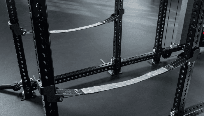 Adjustable strap safety system spanning a power rack front to back